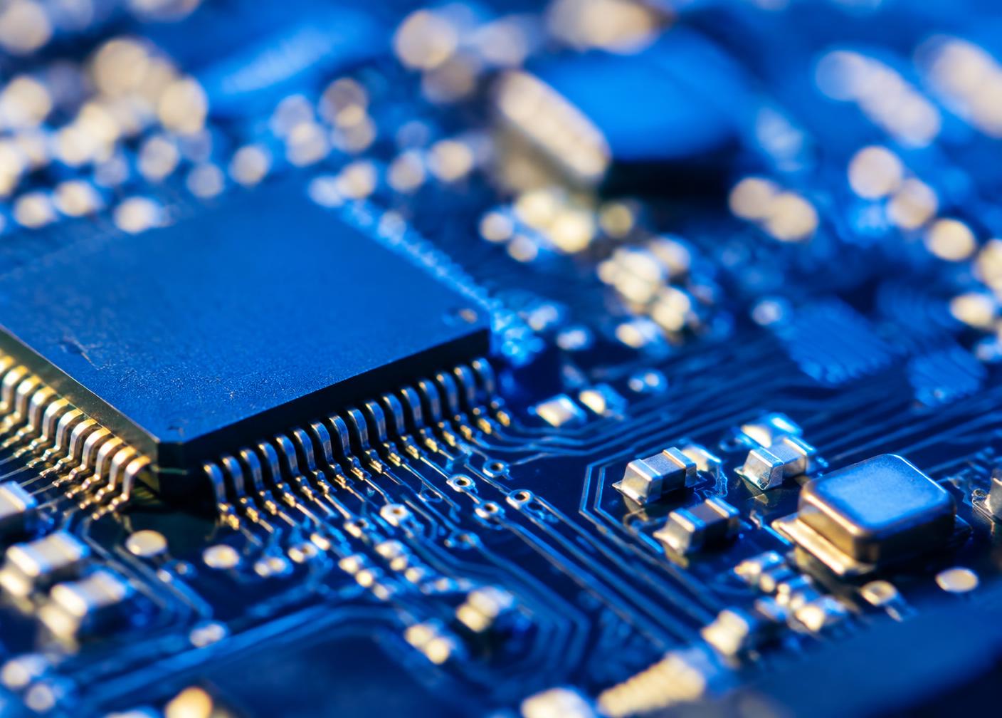 Close-up of a microchip on a blue circuit board
